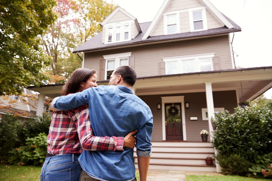 happy couple entering their new home