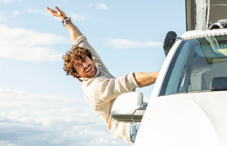 man-siting-on-the-car-window-smiling