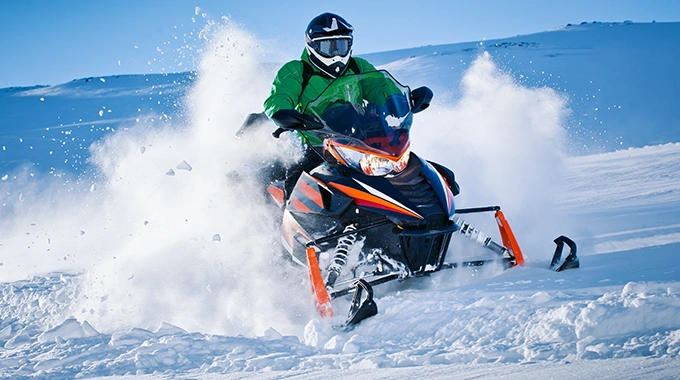 man-driving-snowmobile