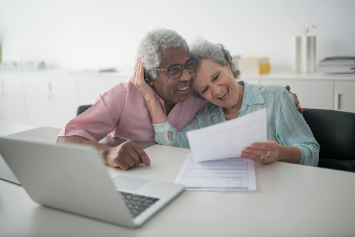 elderly couple looking at their life insurance living benefit